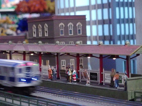 The MTA communter trains runs past the train platform with Santa and riders waiting to ride on the layout at Grand Central Terminal On the layout at Grand Central Terminal the MTA commuter trains runs past the train platform with Santa and riders waiting to ride