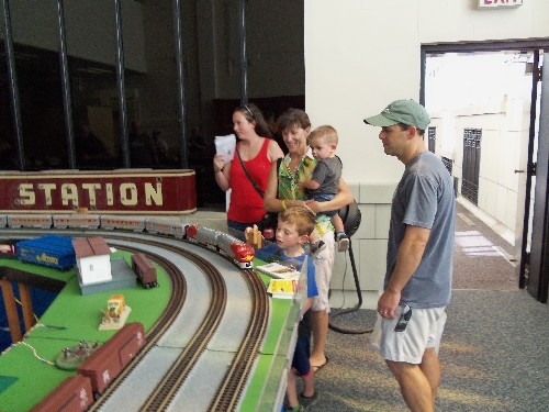 Image with boy and family reacting to movement on the layout at the Wichita Toy Train ClubClub Ambassadors to Lionel July 2016 in Wichita KS