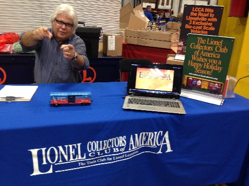 A Lionel Collectors Club of America member greets with enthusiasm at the sign up table at an event  The sign up table at an event has a Lionel Collectors Club of America member greeting with enthusiasm