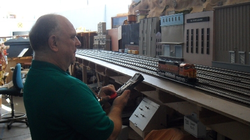 TMB Model Train Club Lionel Club Ambassador has Club Member Randy throttling up his engine the model train layout Club Member Randy throttling up his engine on the TMB Model Train Club Lionel Club Ambassador model train layout