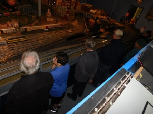 On lookers watched as model trains ran on the layout at the Nassau Lionel Operating Engineers Lionel Club Ambassador October 2016 Open House