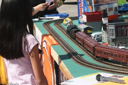Families came by and watched the Lionel Lines Passenger Train Set on the modular layout displayed by Lionel Club Ambassador TMB Model Train Club at the Bellmore Street fair Displayed by Lionel Club Ambassador TMB Model Train Club at the Bellmore Street fair the Lionel Lines Passenger Train Set on the modular layout as families watched the train go by