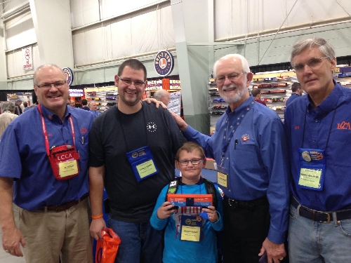 The youngest train enthusiasts enjoy be part of the Lionel Collectors Club of Americas Switching Tracks Traveling boxcar fun LCCAs Switching Tracks Traveling boxcar is held up by one of the young train enthusiasts