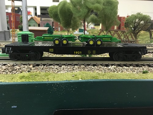 John Deere Flatcar with 2 John Deere spreaders 6-83238 reviewed by Lionel Club Ambassador The Wichita Toy Train Club From the review by Lionel Club Ambassador The Wichita Toy Train Club the John Deere Flatcar with 2 John Deere spreaders 6-83238 is shown in side view