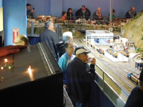 People gather around the model train layout at the October 2016 Open House held by the NLOE Lionel Club Ambassador