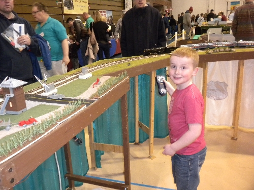 Amongst the crowd gathered at High Wheeler 16 Train Show with Ambassedor to Lionel Chicagoland Association of S Gaugers a boy finds the remote and takes control Amongst the crowd gathered at Harper College in Palatine IL with Ambassedor to Lionel CASG a boy finds the remote and takes control