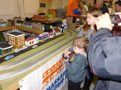 At the October 2016 Open House hosted by the NLOE Lionel Club Ambassador kids use the remote to operate trains