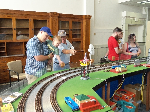 Image of families enjoying the layout accessories at the Wichita Toy Train ClubClub Ambassadors to Lionel July 2016 in Wichita KS