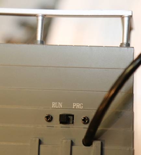 The RunProgram switch on the back of the operating Sawmill with Sound is shown for the review by the Chicagoland Lionel Railroad Club Lionel Club Ambassador The CLRC Lionel Club Ambassador shows the RunProgram switch in the review of the operating Sawmill with Sound