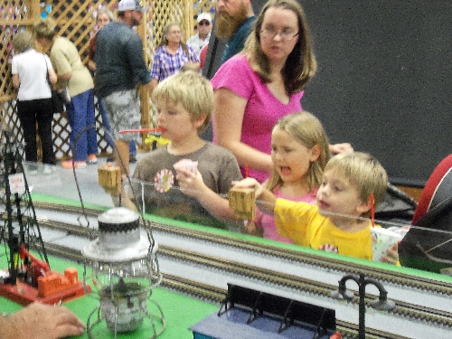 Families gathered to view the trains running on the Wichita Toy Train Club Lionel Club Ambassador layout at the 2016 Kansas State Fair