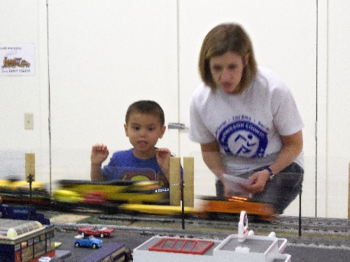 Boy tells mom to look at the train going at top speed during the WTTC Open House Club Ambassadors to Lionel the first weekend of August 2016 At the WTTC Open House Club Ambassadors to Lionel the first weekend of August 2016 a bBoy tells his mom to look at the train going at top speed