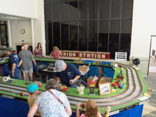 Image of families enjoying the layout accessories at the Wichita Toy Train ClubClub Ambassadors to Lionel July 2016 in Wichita KS