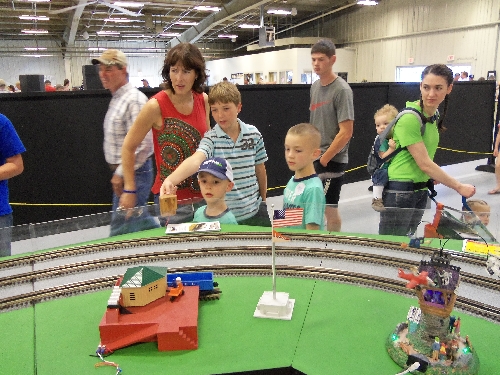 Children gathered to view the trains and accessories on the layout set up by the WTTC Lionel Club Ambassador at the Annual Kansas State Fair