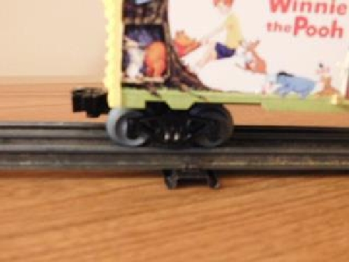 From the product review by Lionel Club Ambassador NLOE images shows the coupler and truck on the Winnie the Pooh 50th Anniversary Boxcar 6-82913 View of the coupler and trucks on the Winnie the Pooh 50th Anniversary Boxcar 6-82913 in the product review by the Nassau Lionel Operating Engineers a Lionel Club Ambassador