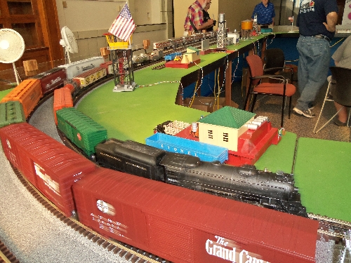 Omage of Train Cars around the bend on the layout at the Wichita Toy Train ClubClub Ambassadors to Lionel July 2016 in Wichita KS